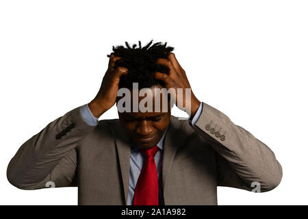 Jungen betonte Geschäftsmann seinen Kopf Holding Stockfoto