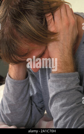 Depressiver junger Mann mit Kopf in den Händen Stockfoto