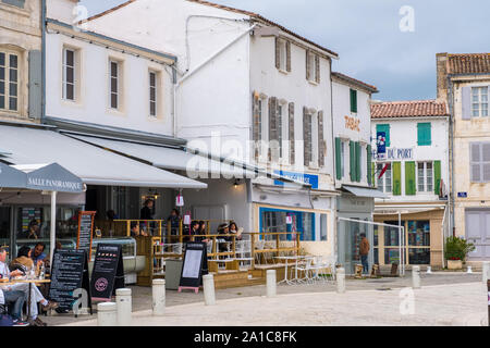 Insel Re, Frankreich - Mai 09, 2019: Die Menschen in der traditionellen französischen Straßencafés am Kai von La Flotte Dorf auf der Ile de Re Insel entspannen in Frankreich Stockfoto