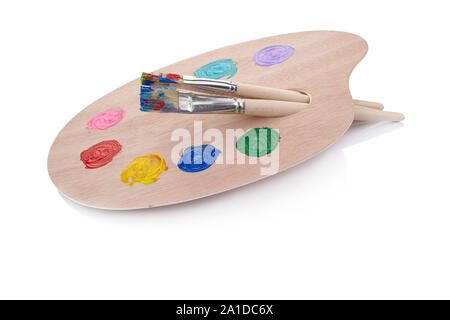 Holz- Palette mit Farben und Pinsel auf weißem Hintergrund Stockfoto