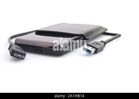 a portable harddisk in  soft leather case and USB cable on white background Stockfoto