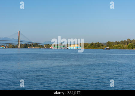 'New Westminster, British Columbia/Kanada - 8/3/2019: Ein Schubschiff Ziehen einer ledcor Gruppe Barge in New Westminster, British Columbia, Kanada, von der Kai in t Stockfoto
