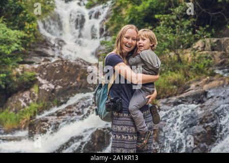 Mutter und Sohn im Hintergrund des wunderschönen, kaskadierenden Datanla-Wasserfalls in der Bergstadt Dalat, Vietnam Stockfoto