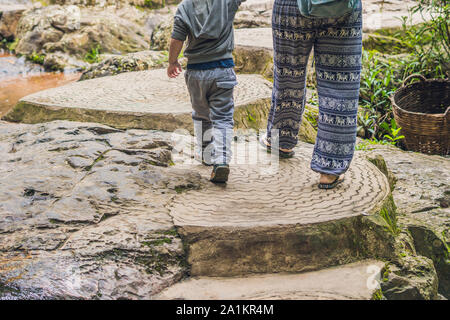 Mutter und Sohn im Hintergrund des wunderschönen, kaskadierenden Datanla-Wasserfalls in der Bergstadt Dalat, Vietnam Stockfoto