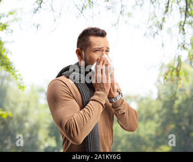 Man Niesen und leiden unter einem Heuschnupfen Allergie im Freien Stockfoto
