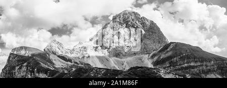 Form der westlichen Wand des Monte Mangart mit Wanderern. Blick von mangart Sattel, Mangartsko sedlo. Grenze zwischen Slowenien und Italien. Europa Stockfoto