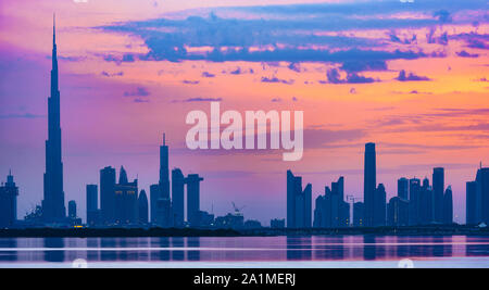 Atemberaubender Blick auf die Silhouette der Skyline von Dubai während eines schönen und dramatischen Sonnenuntergang. Dubai ist die größte und bevölkerungsreichste Stadt in den VEREINIGTEN ARABISCHEN EMIRATEN. Stockfoto