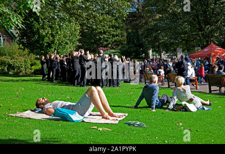 Die Princes Street Gardens West, Edinburgh, Schottland, Großbritannien. 28. September 2019. Nach einem kühlen Start in den Morgen Wetter aufgewärmt, ein männlicher Sonnenanbeter sind nicht durch den Fels Chor gestört Erscheinen unterhalten, eine Menge von Touristen und Einwohner, die in den Gärten, plus Touristen genießen die Ross Brunnen und das Edinburgh Castle vom West End Gärten angesehen. Credit: Bogen Weiß/Alamy Leben Nachrichten. Stockfoto