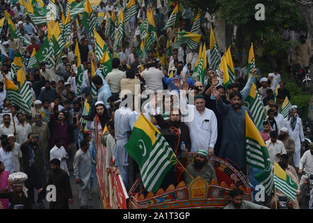 Lahore, Pakistan. 27 Sep, 2019. Aktivisten von Kaschmir Commety Lahore und Tehreek Labbaik Islam Gruppe Flaggen und rufen Parolen wie Sie März während eines anti-indischen Kundgebung Solidarität mit dem Volk von Kaschmir in Lahore am 27. September 2019 zum Ausdruck bringen. Die Vereinigten Staaten wollen Neu Delhi, um schnell einfache Beschränkungen in Kaschmir, einem hohen Beamten auferlegt, sagte Am 26. September erklärte Präsident Donald Trump Bereitschaft zu vermitteln die Spannungen zwischen Indien und Pakistan über das Gebiet zu erleichtern. (Foto von Rana Sajid Hussaiin/Pacific Press) Quelle: Pacific Press Agency/Alamy leben Nachrichten Stockfoto