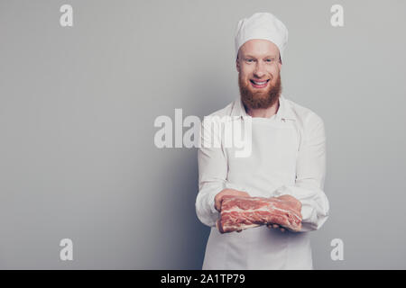 Portrait von er schön schön schön schön fröhlich optimistisch Metzger guy Holding zeigt große Fleisch Stück in den Armen Hände bereit Gericht vorbereiten Stockfoto