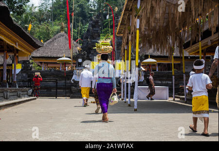 Indonesien Bali, Sept. 20 2019, Frau mit Obstkorb auf Ihrem Kopf für bietet in Tempel Stockfoto