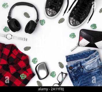 Flach Draufsicht weiblichen Look mit karierten T-Shirt, Jeans, Turnschuhe, Uhren, Kamm, Brille, Geldbörse, und Kopfhörer Stockfoto