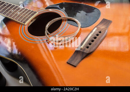 Neue Saiten auf der akustischen Gitarre bereit für Austausch Stockfoto