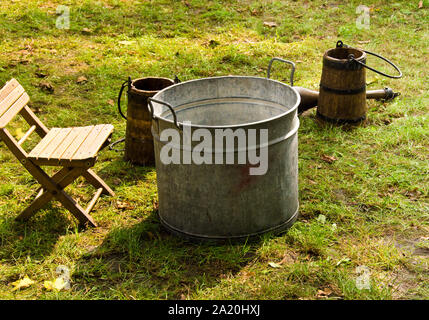 Eine altmodische Waschen trougth ein Jahrgang kind Stuhl, und hölzerne Schiffe Wasser zu bringen Stockfoto