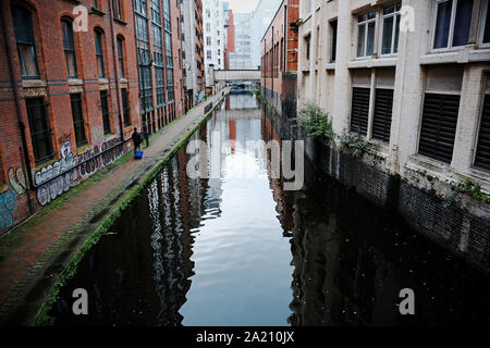 Manchester, UK ein fussgänger Spaziergänge entlang der Rochdale Canal Treidelpfad vorbei durch die Innenstadt. Stockfoto