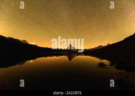 Unglaubliche nacht Stellisee See mit Blick aufs Matterhorn Matterhorn Gipfel in den Schweizer Alpen. Millionen von Sternen in den hellen Himmel. Zermatt Resort Lage, Schweiz. Landschaft Astrofotografie Stockfoto