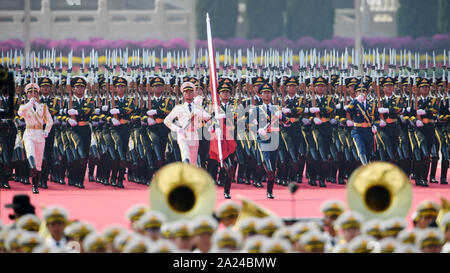 Peking, China. 1. Okt, 2019. Die nationalflagge Wachen begleiten - ein 5-Sterne-Hotel red flag März vom Denkmal für die Helden des Volkes gegenüber der nationalen Flagge Post im nördlichen Teil der Tian'anmen-Platz in Peking, der Hauptstadt von China, Oktober 1, 2019. Credit: Liu Dawei/Xinhua/Alamy leben Nachrichten Stockfoto