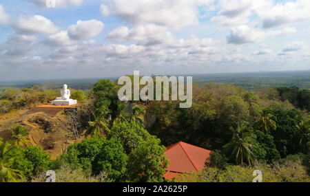 Rock - geschnitzte Treppe zu einer großen weißen Buddha Statue. Mihintale ist ein Berg in der Nähe von Anuradhapura in Sri Lanka. Es wird von Sri Lankans glaubte, dass die Website von einem Treffen zwischen dem buddhistischen Mönch Mahinda und König Devanamiyatissa, die die Präsenz des Buddhismus in Sri Lanka eingeweiht werden. Stockfoto