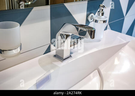 Seifen- und Shampoospender in der Nähe von keramischen Wasser Waschbecken mit Wasserhahn in teuren loft Bad tippen Stockfoto