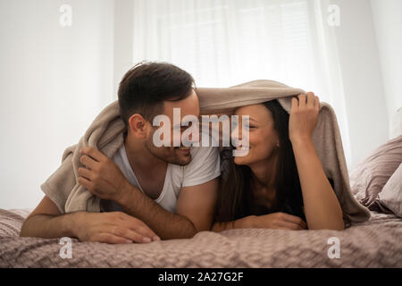Glückliches Paar ist Spaß im Bett. Stockfoto