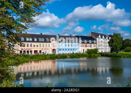 Zweireihiges Gehäuse der Dänischen Architektur in einem Teich im Dorf Horsholm, Dänemark wider. Stockfoto