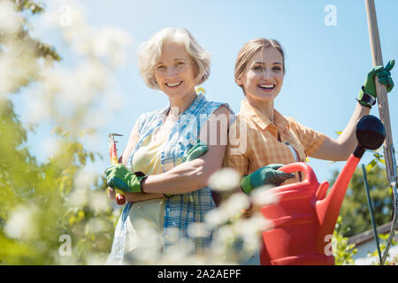 Junge und ältere Frau für Foto in Ihrem Garten posing Stockfoto
