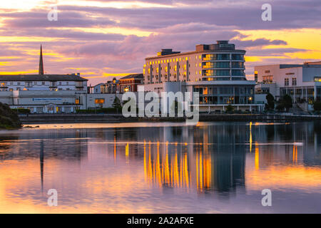 Southport, Merseyside. UK Wetter. 2. Oktober, 2019. Wetter; gedämpften Farben in der Morgendämmerung über dem Resort Marine Lake und renommierte Ramada Plaza Hotel an der Uferpromenade am See Entertainment Complex mit Reflexionen im noch ruhigen Bedingungen. Credit: MediaWorldImages/AlamyLiveNews. Stockfoto