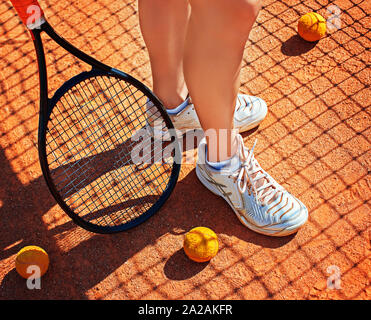 Beine und Schläger der weiblichen Spieler, die in den Hof tagsüber steht. Stockfoto