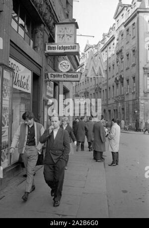 Straßenszene in Leipzig. Die Stadt während der Frühjahrsmesse 1960, oben der Weg ist das Logo der Messe (1 M). Stockfoto