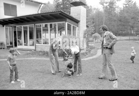 Home Geschichte mit dem Beckenbauer Familie. Im Bild: Die Beckenbauer Familie spielt im Garten mit dem Hund, von Links nach Rechts: Stephan, Brigitte Beckebauer, Thomas, Michael (hinter) und Franz Beckenbauer. Stockfoto