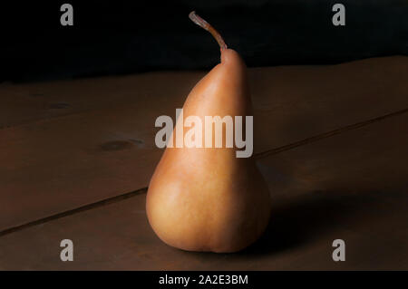 Stillleben, Birne auf einem Holztisch, Chiaroscuro-Technik, dunkle Food-Fotografie oder Low-Key-Licht-Konzept Ölgemälde Stil. Stockfoto