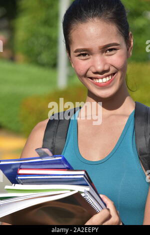 Lächelnd hübsches Mädchen mit Notebooks Stockfoto