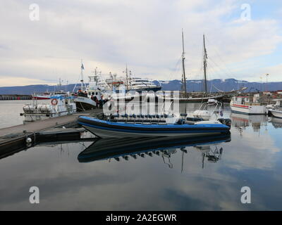 Blick auf den Hafen in Husavik, Walbeobachtung Islands Hauptstadt, mit einer Rippe, starr - geschält aufblasbares Boot am Steg vertäut. Stockfoto