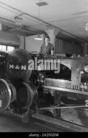 Eine Arbeiterin Rotationsdruckmaschine kontrolliert Sterben in den Werken des Maschinenbaukonzerns MAN (Maschinenfabrik Augsburg-Nürnberg), Deutschland 1930er Jahre. Ein Arbeitnehmer, der die Steuerung der Rotationsdruckmaschine, die in den Anlagen der mechanischen Engineering Company MAN (Maschinenfabrik Augsburg-Nürnberg), Deutschland 1930. Stockfoto