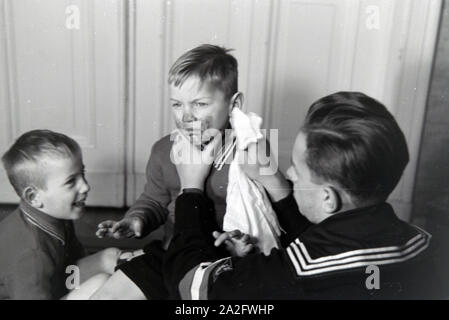 Mitglieder einer kinderreichen Familie helfen sich gegenseitig, Deutsches Reich 30er Jahre. Mitglieder einer Großfamilie gegenseitig helfen, Deutschland 1930. Stockfoto