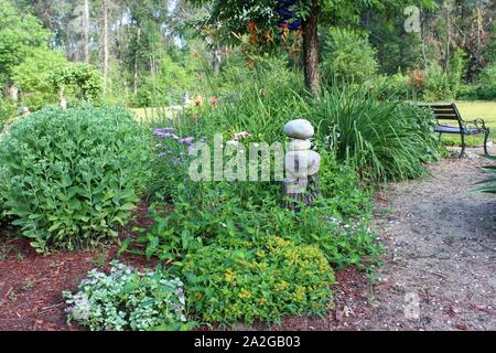 Eine Vielzahl von Pflanzen wachsen auf einem Gartenweg Stockfoto