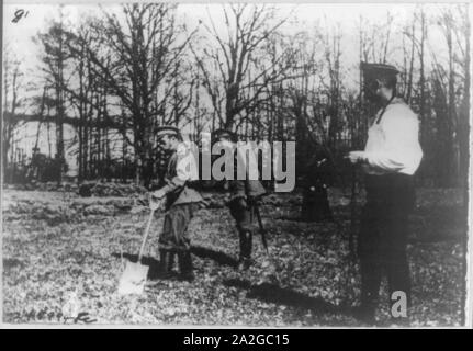 Kaiser Nikolaus II. in der Küche Garten arbeiten in Zarskoje Selo. Hinter ihm der Offizier der Wache Stockfoto