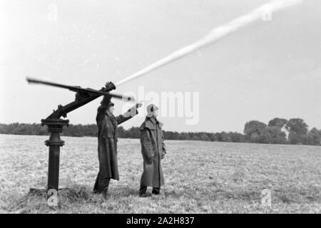 Eine Regenanlage im landwirtschaftlichen Einsatz bei einem Kartoffelacker, Deutschland 1930er Jahre. Eine Sprinkleranlage in der landwirtschaftlichen Nutzung in einem Kartoffelfeld, Deutschland 1930. Stockfoto