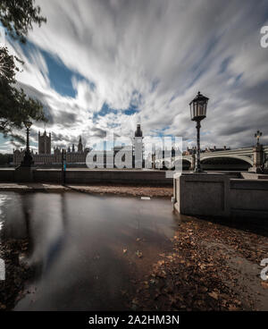 Flauschigen weißen Wolken erstrecken sich über die Häuser des Parlaments nach den schweren Überschwemmungen in London, England. Stockfoto