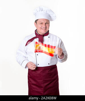 Küchenchef mit der Flagge von Spanien vor einem hellen Hintergrund. Im mittleren Alter Mann. Stockfoto