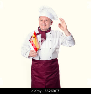 Küchenchef mit der Flagge von Spanien vor einem hellen Hintergrund. Im mittleren Alter Mann. Stockfoto