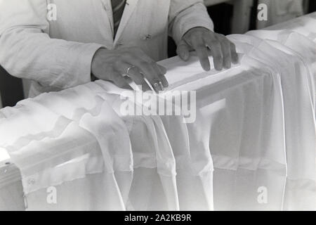 Hände des Vorarbeiters Fallschirm in einer Näherei, Deutschland 1940er Jahre. Hände von einem häuptling an einem Fallschirm nähen Fabrik, Deutschland 1940. Stockfoto