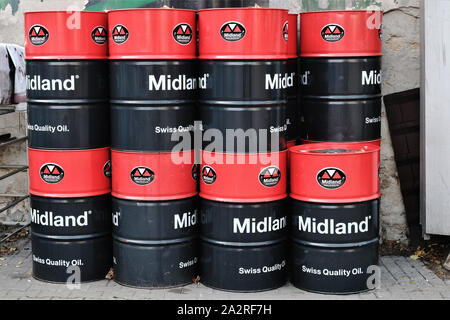 Barrel 'Midland Swiss Quality Oil' Motoröl im Hof eines Service Garage gestapelt. Stockfoto