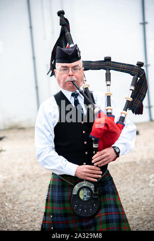 Traditionell Schotte mit Dudelsack an Blair Castle, dem Stammsitz der Herzöge und Grafen von Atholl gekleidet. Die Burg ist 740 Jahre alt. Stockfoto