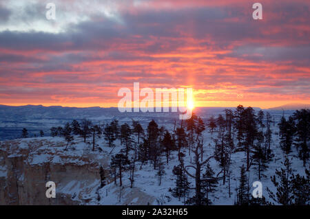 Die Sonne über Bryce Canyon National Park in Utah in einer kalten, verschneiten Morgen Stockfoto