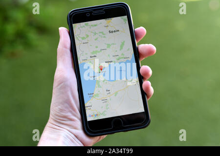 Gibraltar, 04. Oktober 2019: eine Hand, die ein iphone mit Google Maps App und konzentriert sich auf die Region von Gibraltar Stockfoto