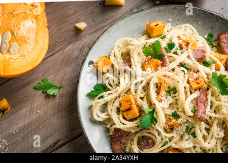 Kürbis und Speck Nudeln mit geriebenem Parmesan. Hausgemachte spaghetti Kürbis Pasta auf weißen, bis zu schließen. Saisonale Herbst essen. Nudeln Kürbis Carbonar Stockfoto