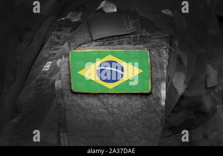 Flagge von Brasilien auf Soldaten arm. Flagge von Brasilien über militärische Uniformen (Collage). Stockfoto