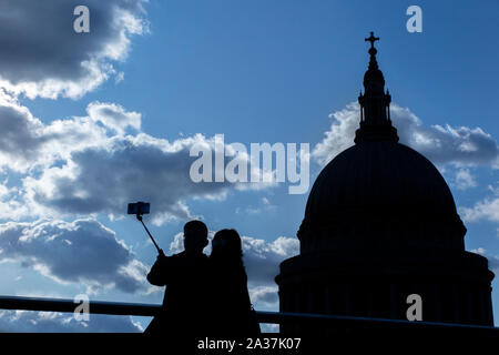 Touristen nehmen eine selfie mit einem selfie Stick von St Paul's Cathedral und die Skyline von London Stockfoto