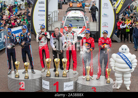 Llandudno, Wales, UK. 6. Okt 2019. Nicolas Gilsoul, Thierry Neuville, Martin Jarveoja, Ott Tanak, Sebastien Ogier, Julien Ingrassia feiern auf dem Podium des GB Welsh Rally 2019 Credit: Jason Richardson/Alamy leben Nachrichten Stockfoto